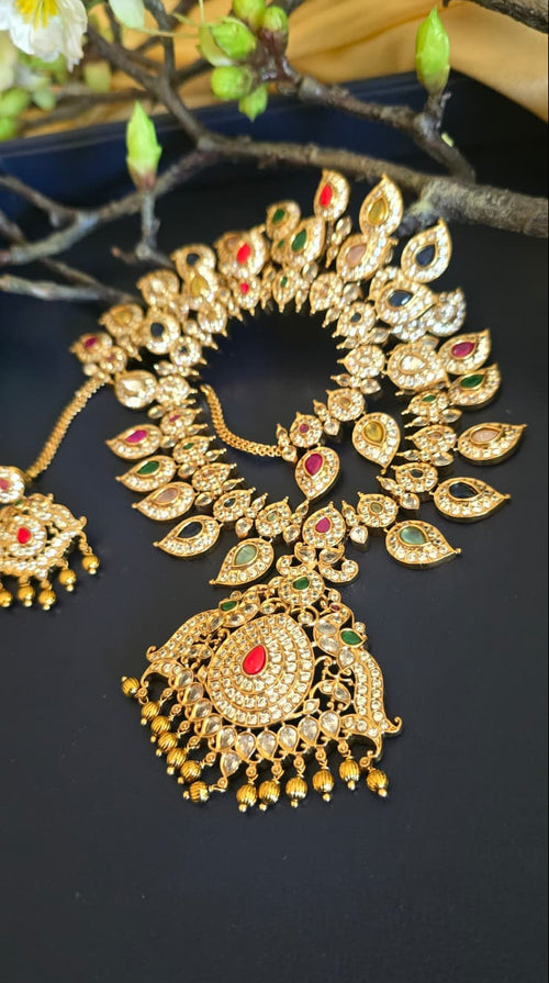 Close-up of multicolour teardrop necklace and ornate pendant
